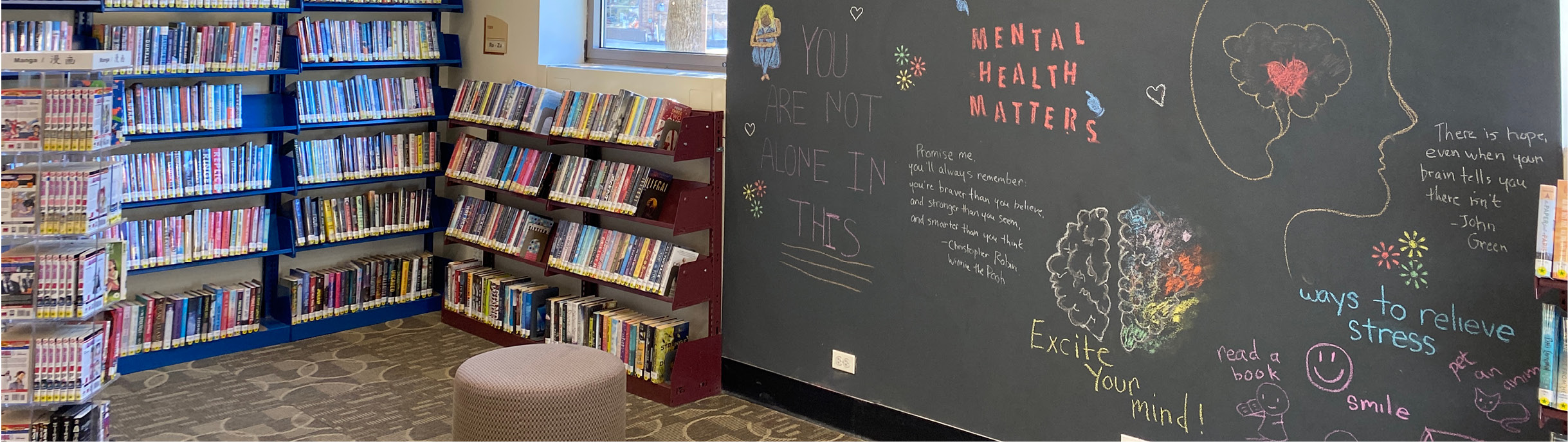 Image of the teen room with bookshelves and a full-wall blackboard. 