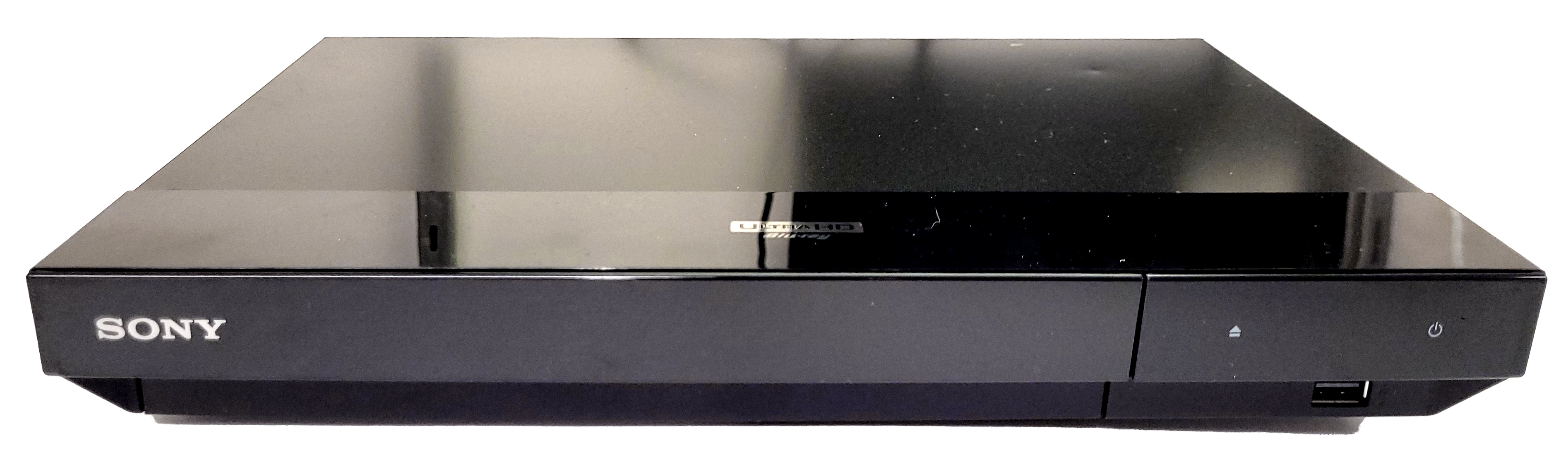 a black 4k ultra hd blu-ray player with a glossy top, sony logo, and various other labels on its side.