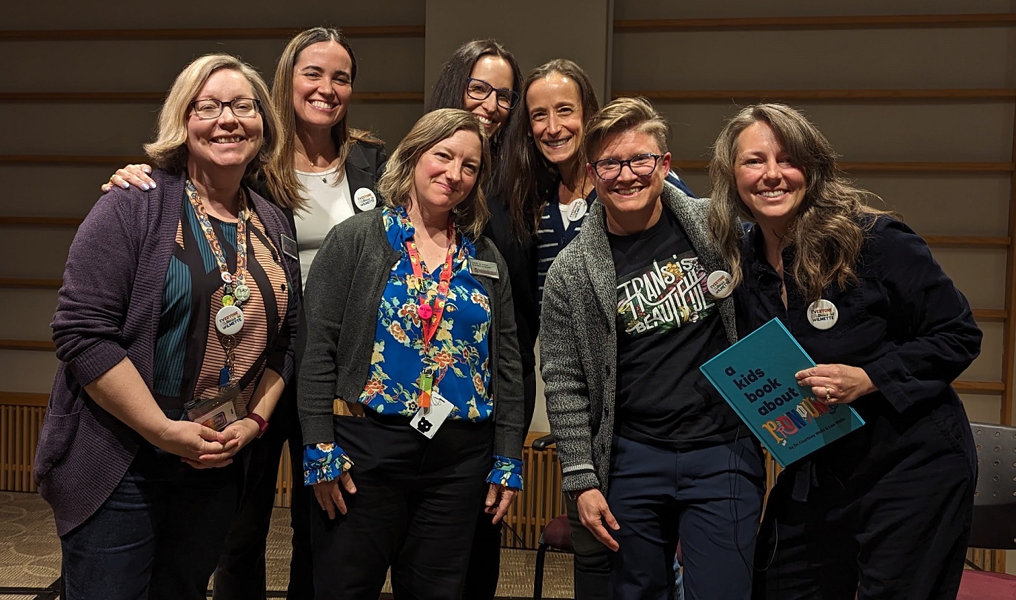 seven white people pose for a photo