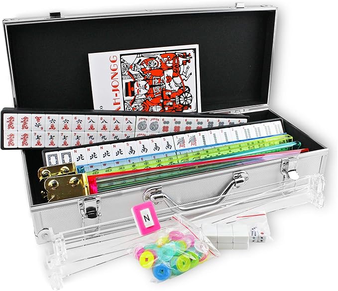 Open mahjong case showing the contents, which include tiles, racks, chips, and an instruction booklet.