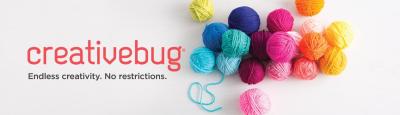 Balls of colorful yarn with Creative Bug in red type