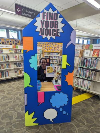 Colorful wooden booth with smiling person inside