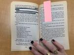 text on the page of a book with some sentences blacked out