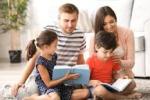 light skinned parents reading to two children