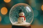 Close-up of a snow globe with a snowperson inside, against a dark bokeh lights background 