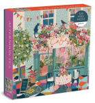 Jigsaw puzzle box showing an abstractly illustrated cafe scene. 