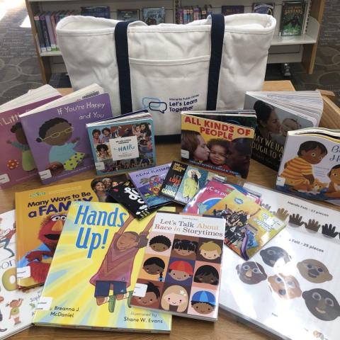 picture books, felt cutouts, and a canvas tote bag